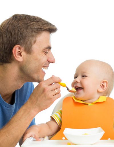 31913648 - smiling baby eating food